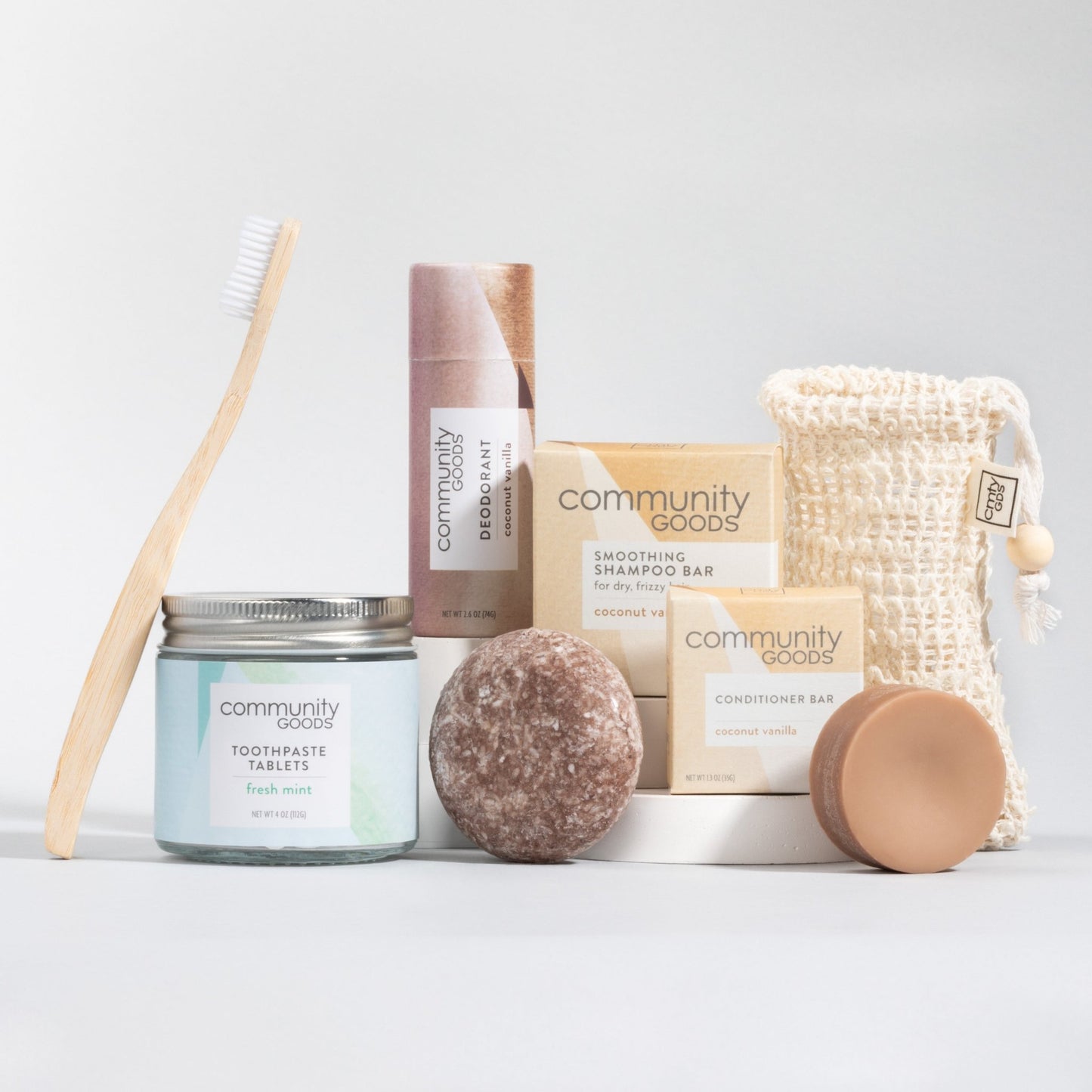 Sustainable personal care bundle by Community Goods with the best shampoo bar, best plastic-free deodorant, best toothpaste tablets, and bamboo toothbrush